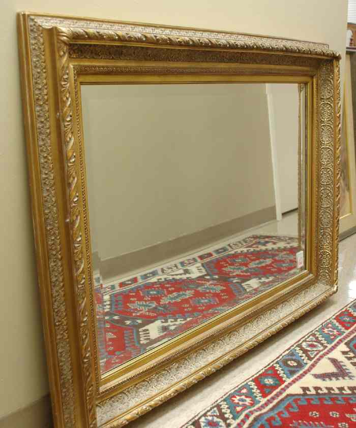 Appraisal: A GILT WOOD AND GESSO BEVELED WALL MIRROR Gold leaf