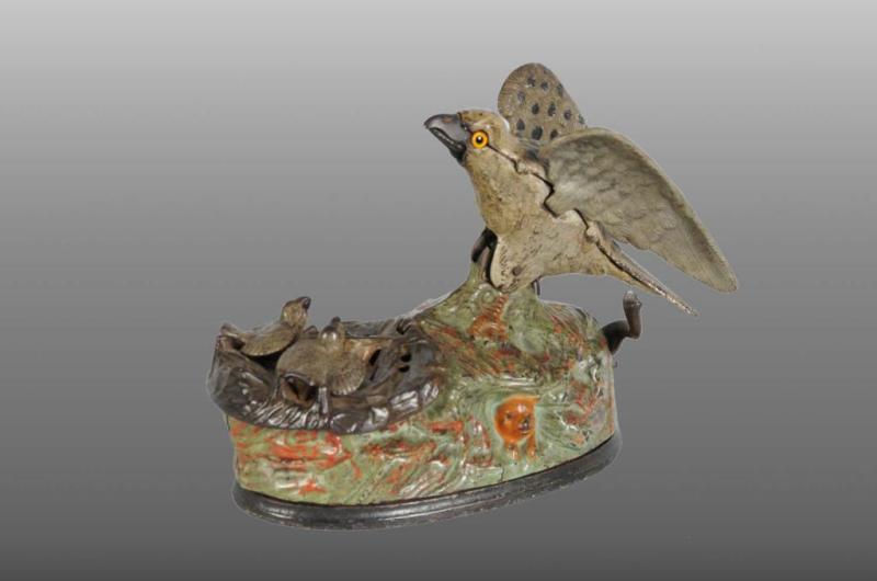 Appraisal: Cast Iron Eagle Eaglettes Mechanical Bank Description Manufactured by J