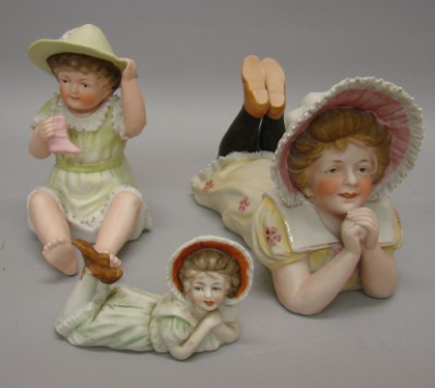 Appraisal: -Piano Figurines children with hats L Girl on stomach dressed