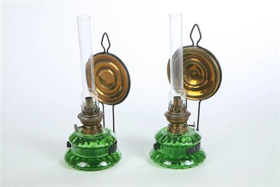 Appraisal: PAIR OF HANGING OIL BRACKET LAMPS Clear green ribbed fonts