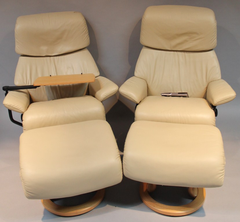 Appraisal: A pair of modern Stressless Ekornes swivel chairs and footstools