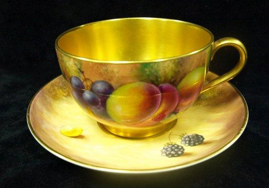 Appraisal: A breakfast cup and saucer decorated grapes and peaches by