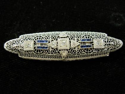 Appraisal: White gold and diamond filigree broochPetite cut diamonds accented by