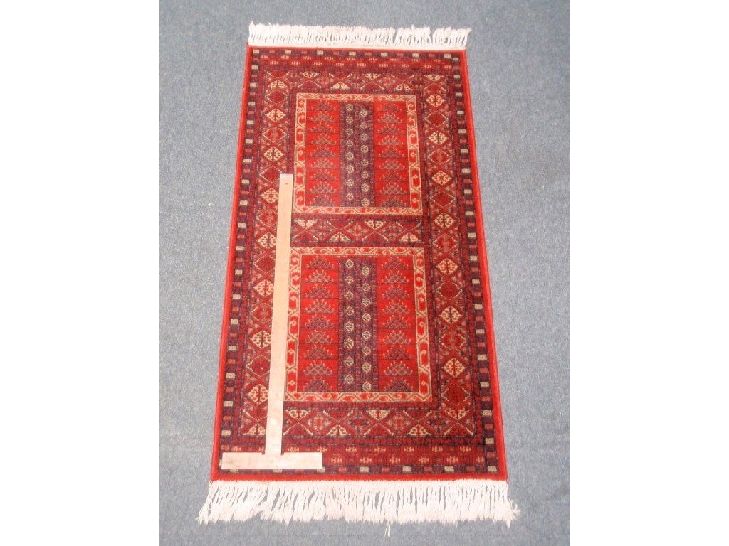 Appraisal: A red ground two panel rug cm x cm