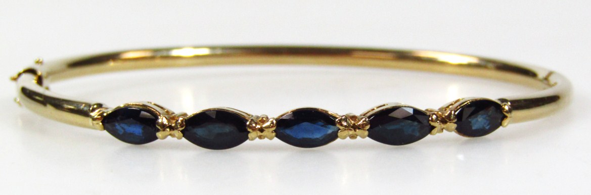 Appraisal: A bangle set with five oval blue stones yellow metal