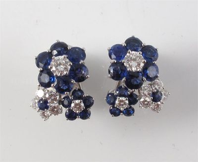 Appraisal: A pair of diamond and sapphire cluster earrings Each with