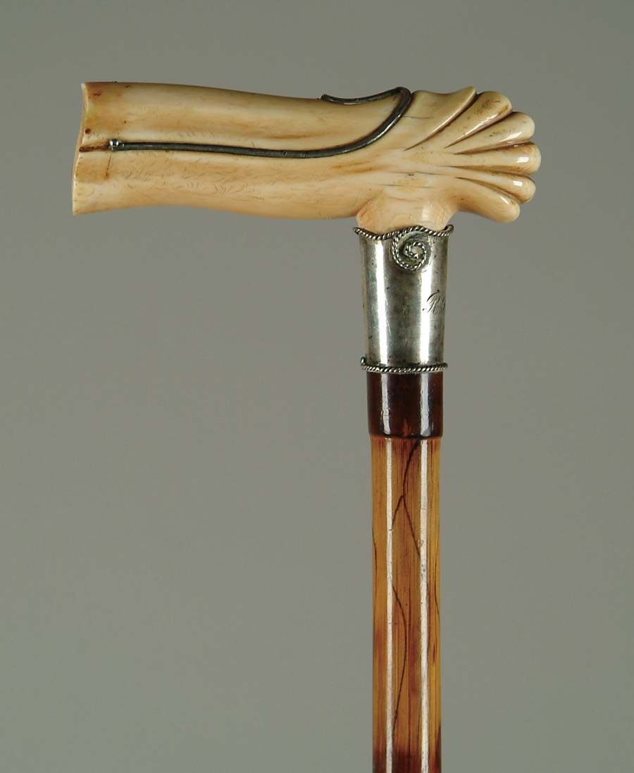 Appraisal: CANE SILVER AND IVORY CANE The carved ivory L-shaped handle