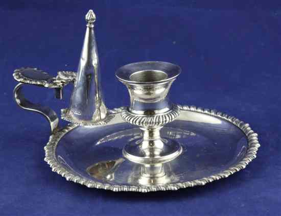 Appraisal: An Edwardian silver chamberstick with extinguisher of circular form with