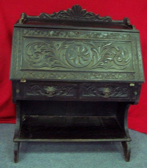 Appraisal: A late Victorian carved and stained oak bureau the fall