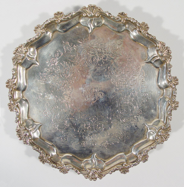 Appraisal: Victorian shaped silver salver chased with flowers London cm diameter