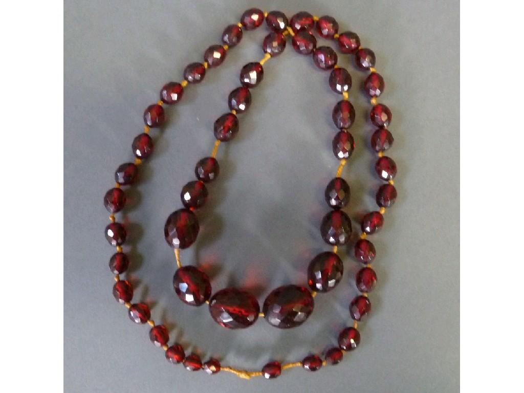 Appraisal: SINGLE STRAND NECKLACE OF GRADUATED AND FACETED RED AMBER OVAL