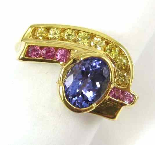 Appraisal: TANZANITE AND FOURTEEN KARAT GOLD RING set with round-cut yellow