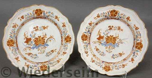 Appraisal: Pair of French faience plates th c with scalloped borders