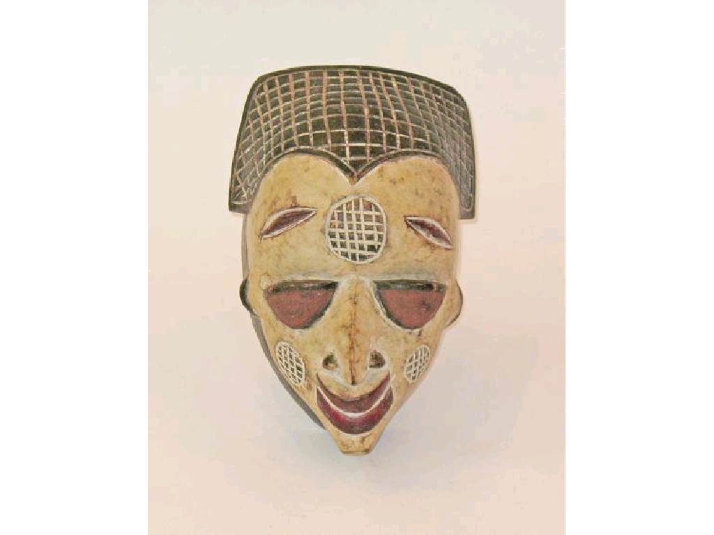 Appraisal: AN AFRICAN BAULE MASK with painted polychrome decoration with red