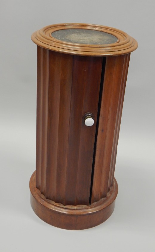 Appraisal: A Victorian pedestal pot cupboard the top with a black