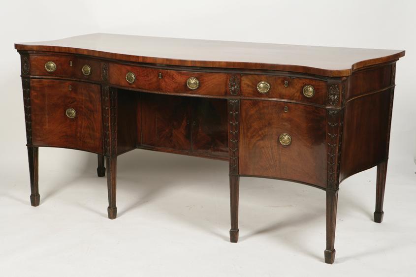 Appraisal: A GEORGE III MAHOGANY SERPENTINE FRONTED SIDEBOARD the shaped top