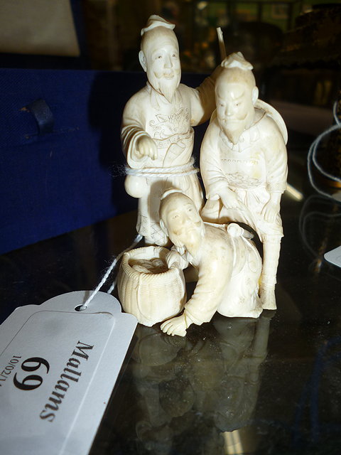 Appraisal: AN ANTIQUE CARVED IVORY FIGURAL GROUP of three bearded gentlemen