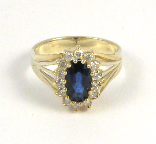 Appraisal: SAPPHIRE DIAMOND AND FOURTEEN KARAT GOLD RING centering an oval-cut