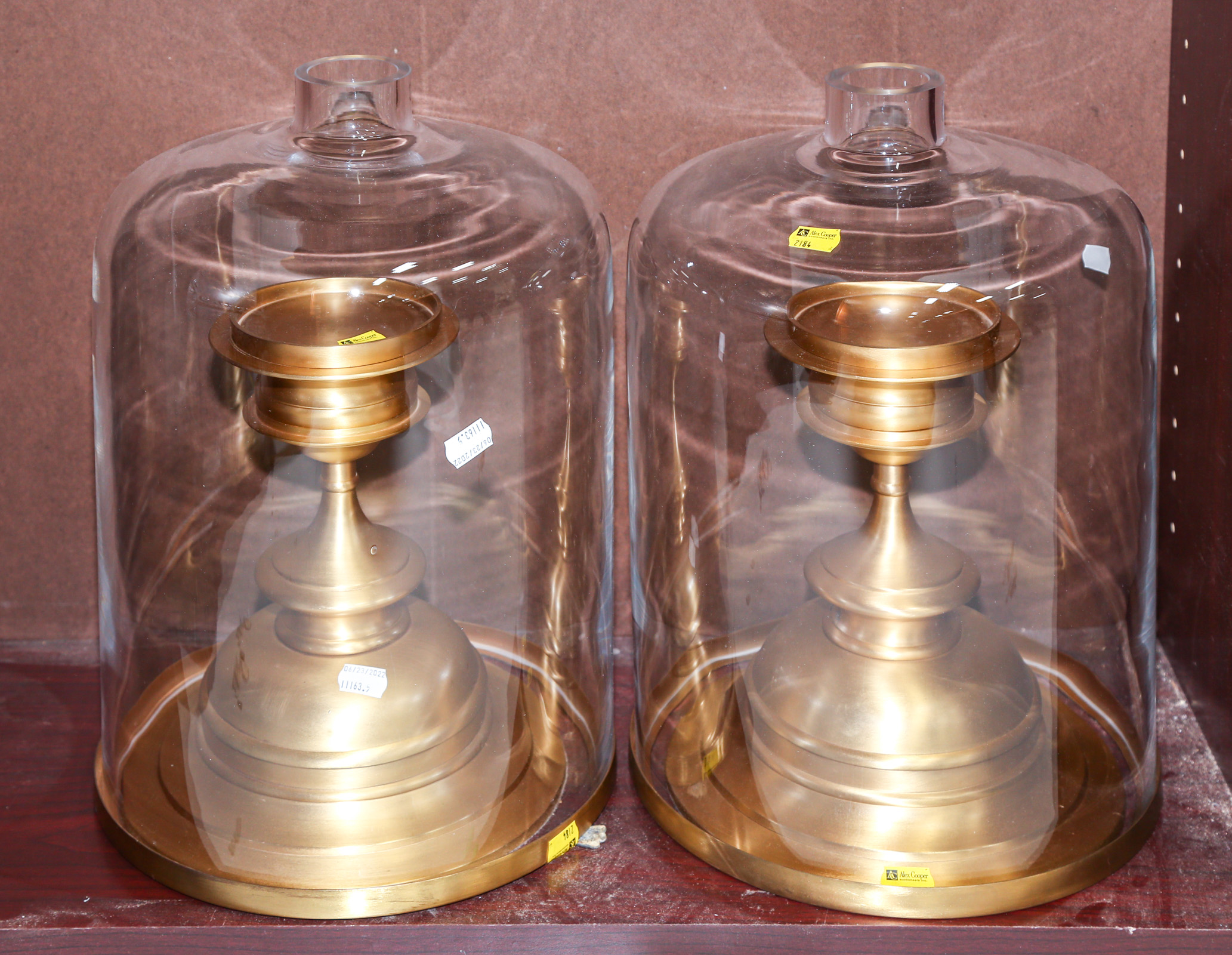 Appraisal: TWO BRASS CANDLE HOLDERS With glass bell shades in H