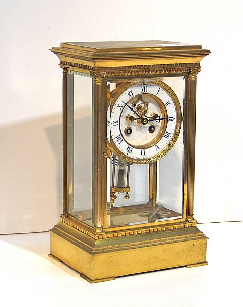 Appraisal: A French Neoclassical style brass four glass regulator mantel clock