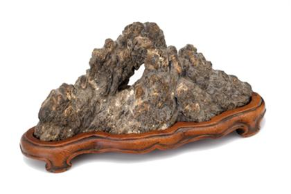 Appraisal: Small Chinese grey lingbi scholar's rock Of pierced mountainous form