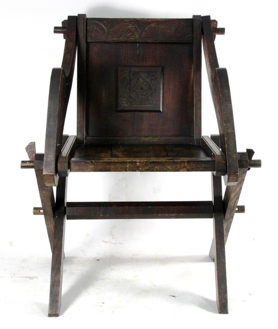 Appraisal: An oak 'Glastonbury' chair with carved cresting rail and applied