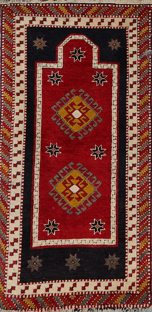 Appraisal: A CAUCASIAN RED GROUND PRAYER RUG with polychrome hooked diamond