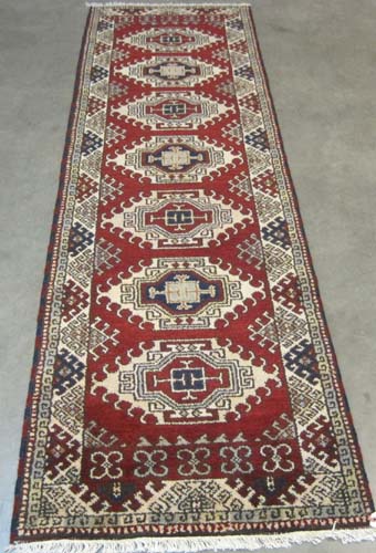 Appraisal: HAND KNOTTED ORIENTAL RUNNER Indo-Persian tribal repeating geometric medallion design