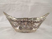 Appraisal: A cast continental silver open navette shaped basket with animal