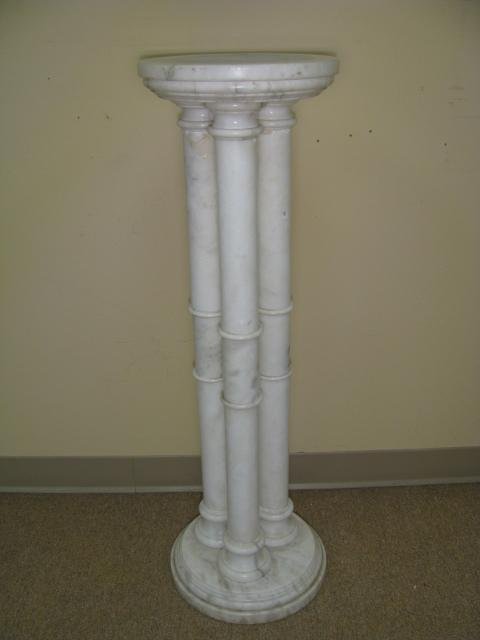 Appraisal: Carved polished marble pedestal stand with three columns measures tall