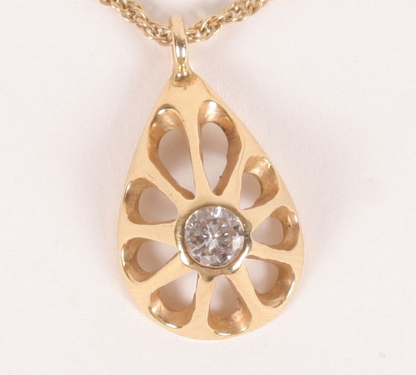 Appraisal: Gold K pendant on chain bezel set with one round