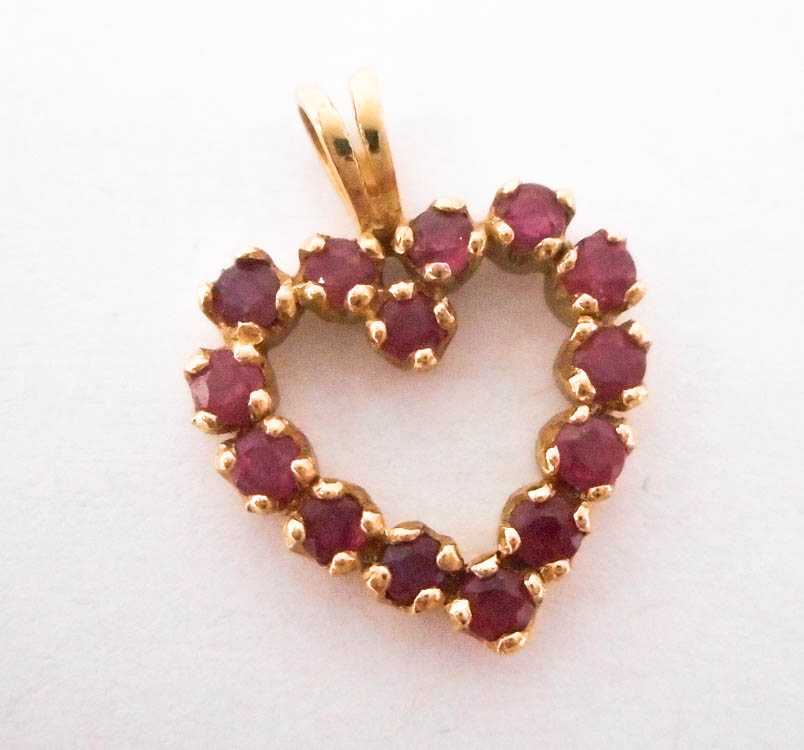 Appraisal: RUBY AND FOURTEEN KARAT GOLD PENDANT The yellow gold open