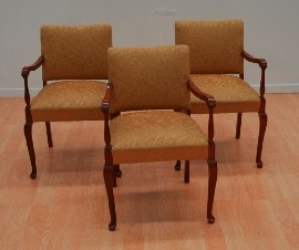 Appraisal: A set of three mahogany and fabric upholstered dining armchairs