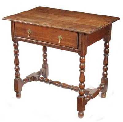 Appraisal: An oak side table the moulded edge boarded top above