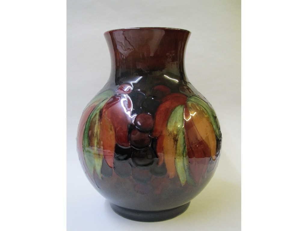 Appraisal: A Moorcroft baluster vase painted with grape and leaf design