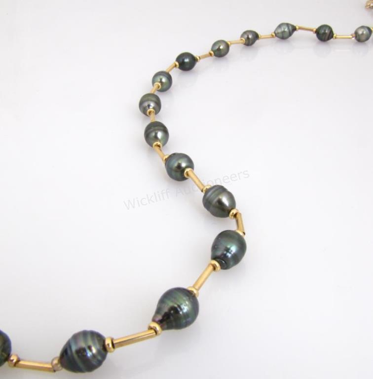 Appraisal: A K yellow gold long mm black baroque pearl necklace