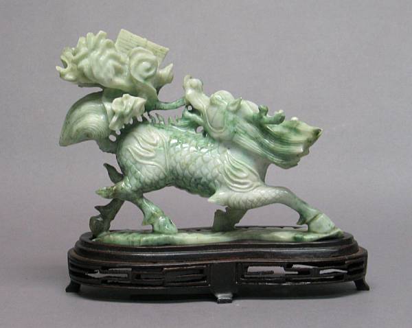 Appraisal: A mottled green jadeite carving of a qilin Shown striding