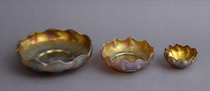 Appraisal: THREE TIFFANY FAVRILE GLASS GRADUATED BOWLS Etched mark L C