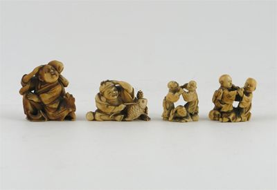 Appraisal: Four Japanese ivory okimono netsukes carved as figures in various