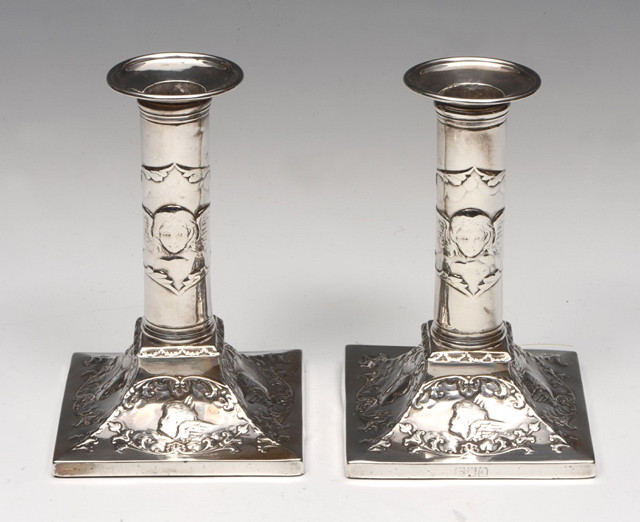 Appraisal: A PAIR OF LATE VICTORIAN SILVER CANDLESTICKS with embossed cherub