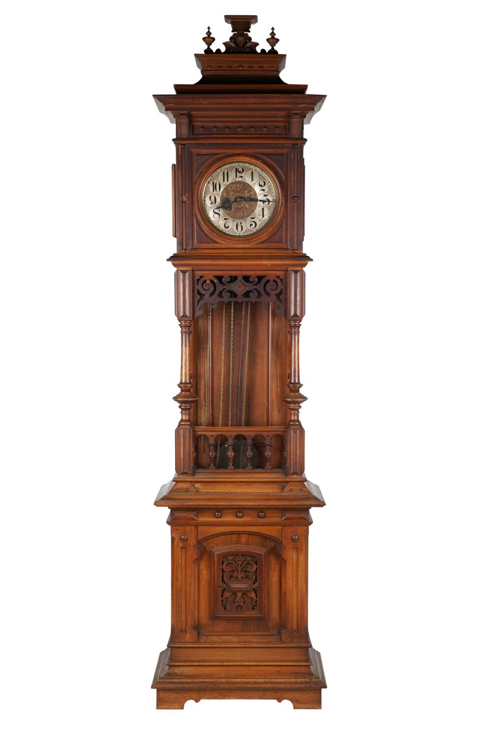 Appraisal: CARVED WALNUT TALL CASE CLOCKunsigned with pendulum and three brass