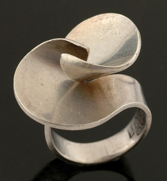 Appraisal: A silver ring by Georg Jensen Of abstract twist design