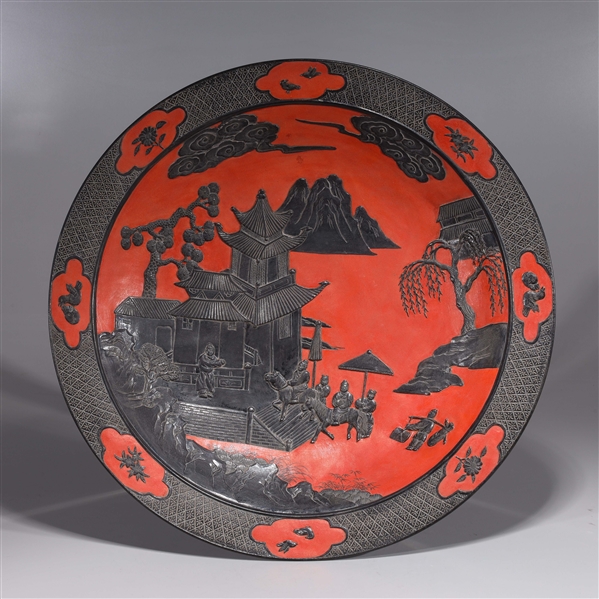 Appraisal: Chinese red and black porcelain charger with courtyard scene and