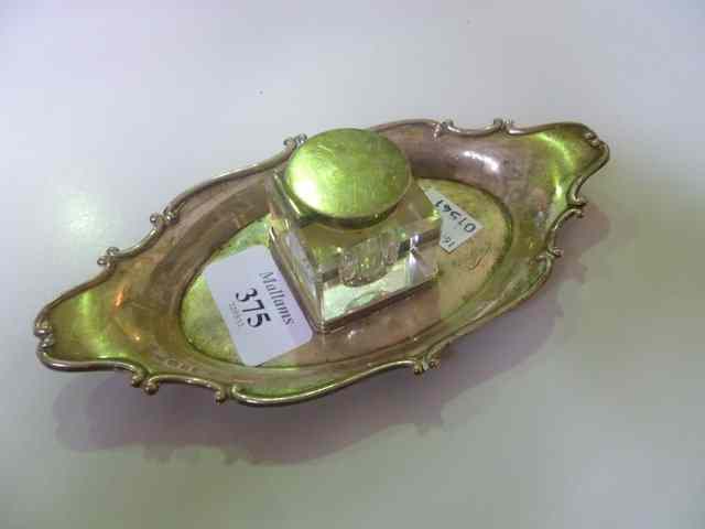 Appraisal: A SILVER INK STAND of boat shaped form with stylised