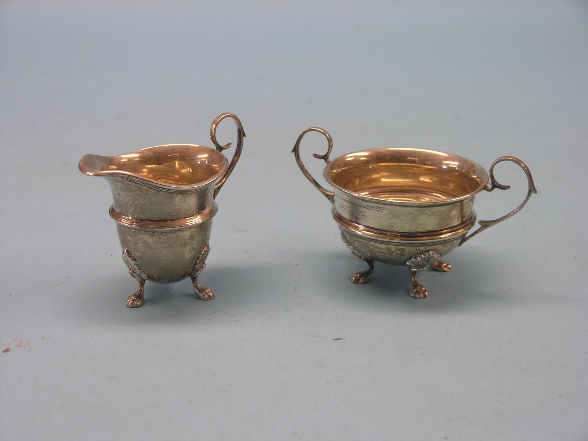 Appraisal: A silver cream jug and matching two-handled sugar bowl helmet-shape