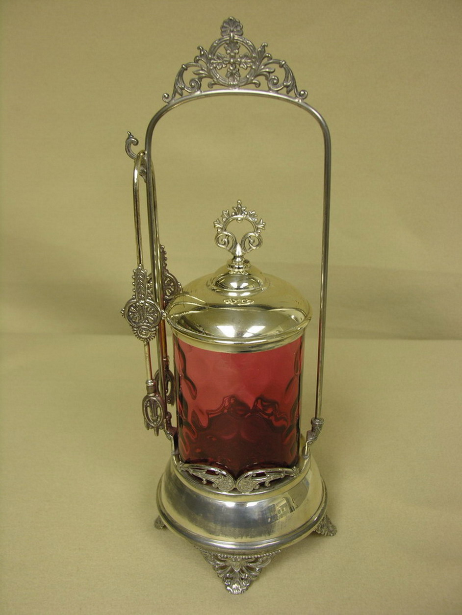 Appraisal: CRANBERRY GLASS PICKLE CASTER Inverted thumbprint pattern Base stamped Guaranteed