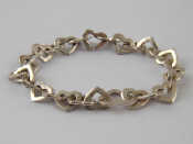 Appraisal: A silver bracelet designed as entwined hearts approx cm long