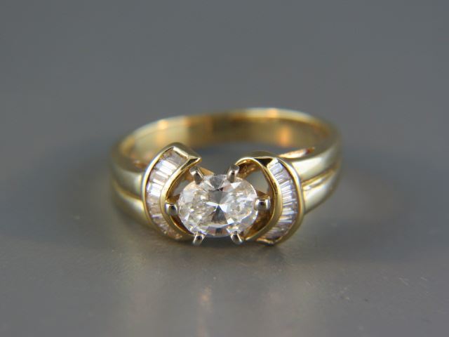 Appraisal: Diamond Ring oval center diamond weighing carat surrounded by baguette