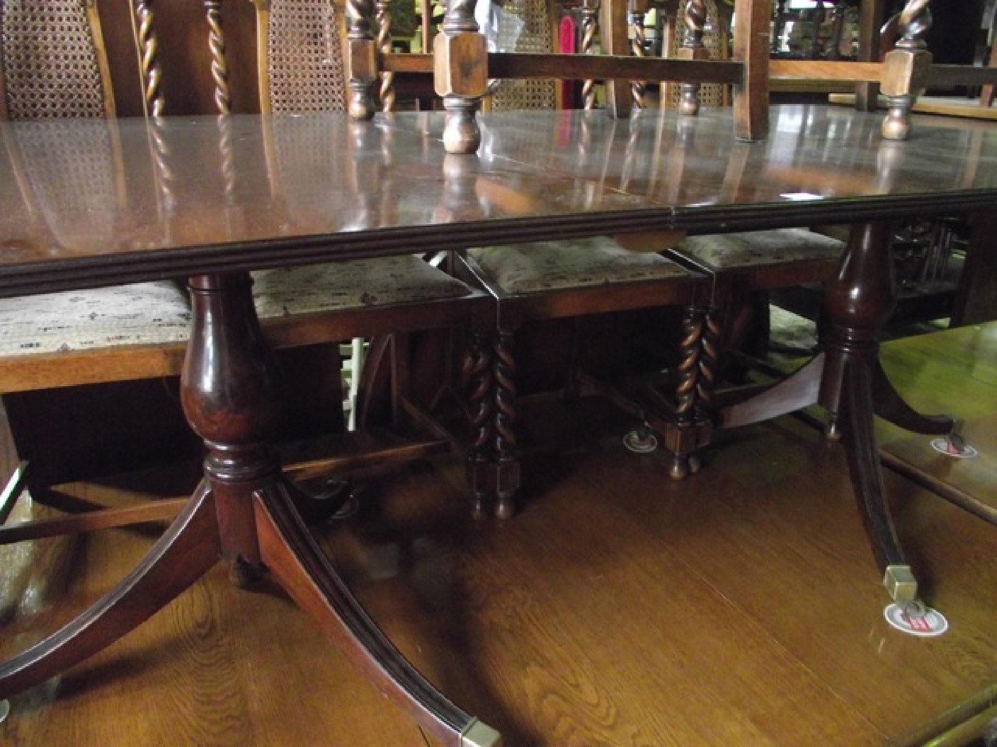 Appraisal: A reproduction Regency style mahogany twin pillar dining table with