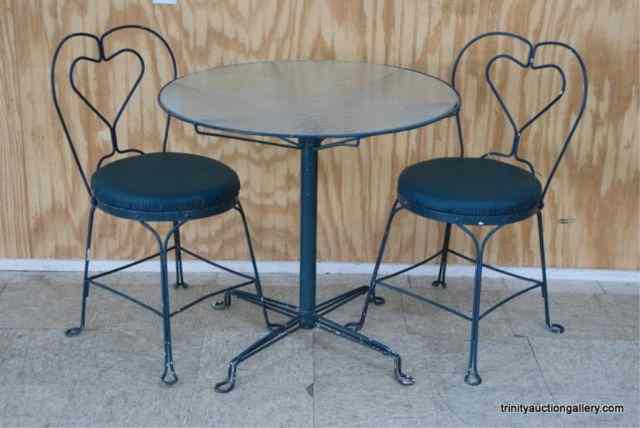 Appraisal: Bent Iron Glass Top Bistro Table ChairsFrom the estate is